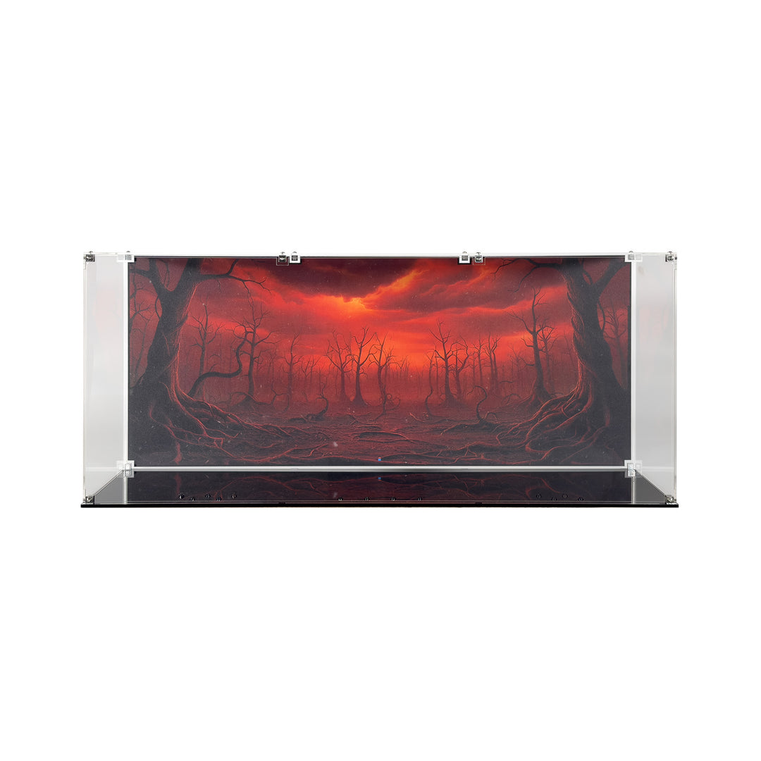 A clear acrylic display case with black base is assembled and showcasing the background art, which is a red and ominous sky with twisted tree trunks and dead branches.
