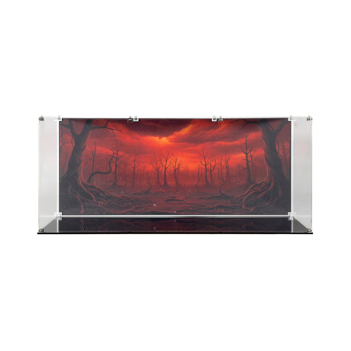 A clear acrylic display case with black base is assembled and showcasing the background art, which is a red and ominous sky with twisted tree trunks and dead branches.