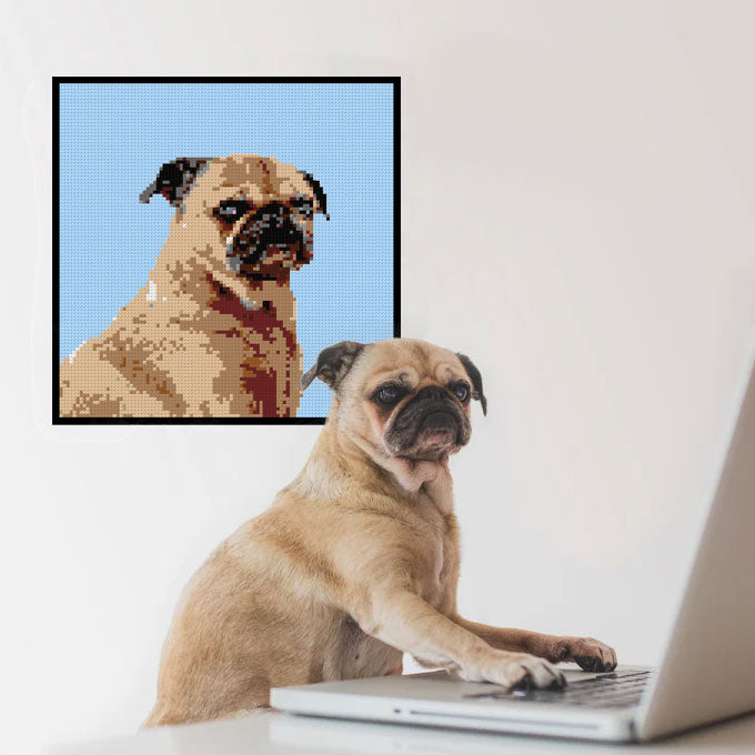 dog at computer with lego mosaic of him on the wall.